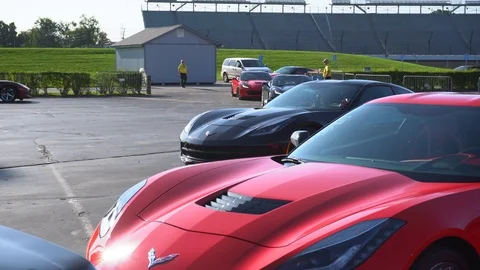 Overview from a red C7 corvette as others assemble and park. Stock Footage 122617611