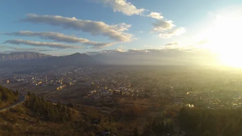 Overview of settlement amidst mountain ranges Stock Footage 89966087