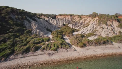 Overview of white sandstone mountains with 2 people walking on Gerakas beach. Stock Footage 240620211
