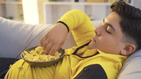 Overweight kid eats chips. Stock Footage 218968697
