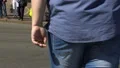 Overweight male crossing street, health problems caused by obesity, society HD Footage
