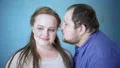 Overweight male whispering compliment in girlfriends ear, feelings expression HD Footage