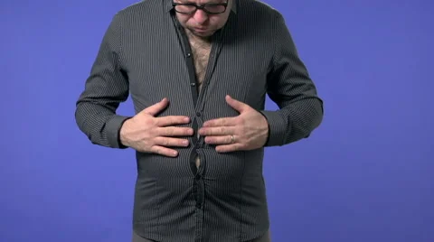 Overweight man buttoning a shirt. He finds out he has gained too much weight. Stock Footage 45947676