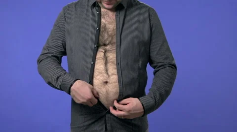 Overweight man buttoning a shirt. High definition video shot on blue screen. Video stock 45947889