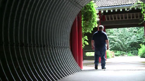 OVERWEIGHT MAN COMING AND GOING IN CORRUGATED TUNNEL Video stock 25103441