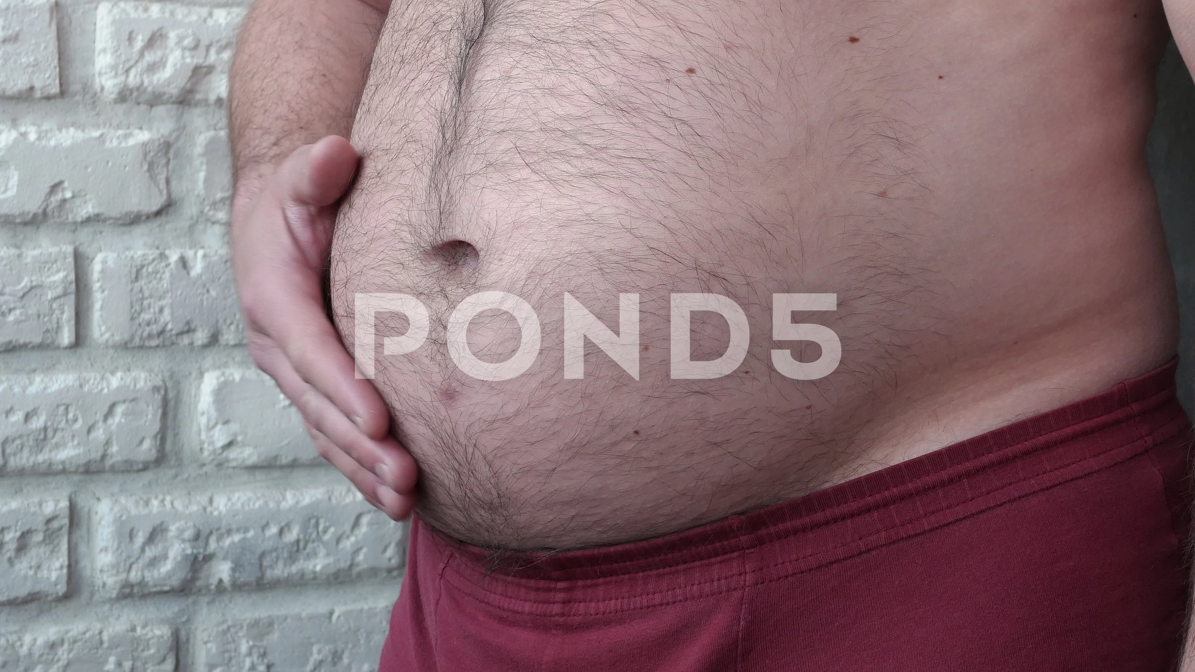 An overweight man demonstrates a big bel, Stock Video