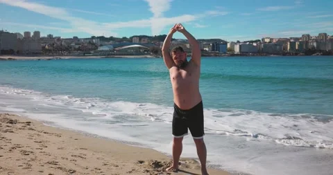 An overweight man does morning exercises for a healthy lifestyle. Stock Footage 172143604
