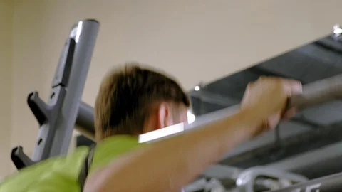The overweight man does squats with squats with a weight disc for a barbell Video stock 111887362
