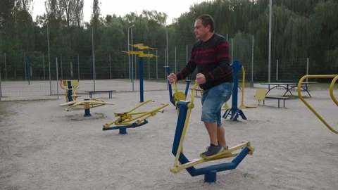 An overweight man is engaged in running exercises Stock Footage 158947331