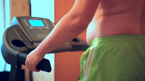 Overweight man on the treadmill Видео 52997327