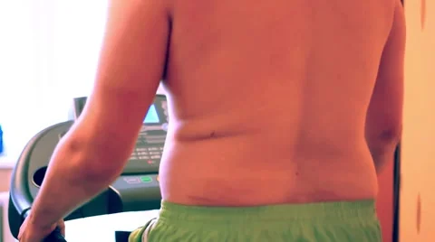 Overweight man on the treadmill Видео 52997532