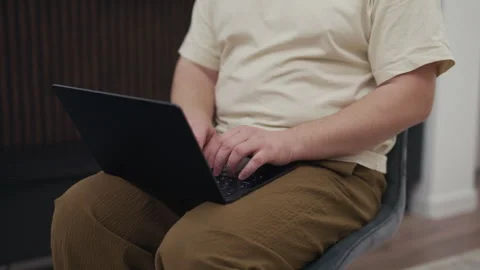 Overweight man typing on laptop computer keyboard at home Stock Footage 340929685