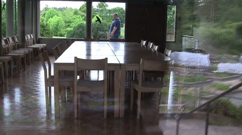 OVERWEIGHT MAN WALKING BACK AND FORTH SEEN THROUGH MEETING ROOM WINDOW Stock Footage 25102152