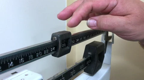 Overweight man weighing himself Stock Footage 67025555
