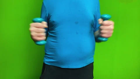 Overweight man working out with dumbbells focusing on health and weight loss. Stock-Footage 340252728