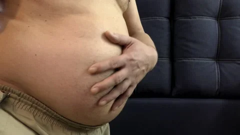 Overweight men stroke their big and well-fed belly. Stock Footage 149476294