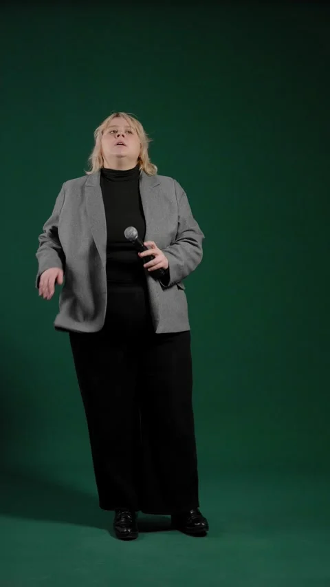 An overweight woman checking microphone before performance. Body positivity. Stock Footage 295184820