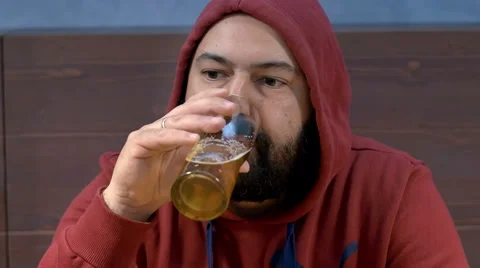 Overweight young man drinking beer in a pub Stock-Footage 49767341