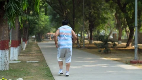 An overweighted man jogging to reduce weight - weight-loss,  fat-loss, cardio... Stock-Footage 264015974