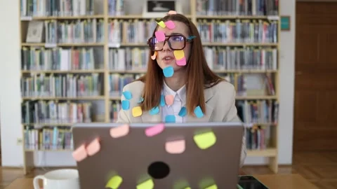 Overwhelmed office worker surrounded by sticky note reminders Stock Footage 341657196