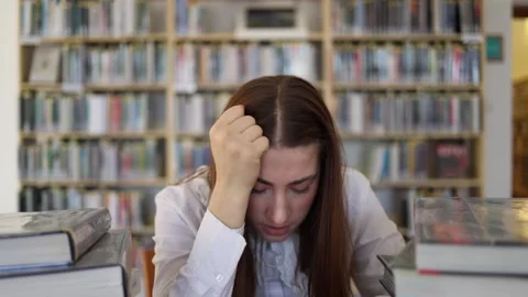 Overwhelmed student reaches breaking point after exhausting study session Video stock 341655980