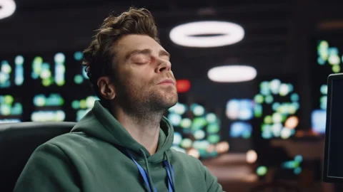 Overworked analyst drinking coffee coding at computer data center workplace Stock-Footage 260243524