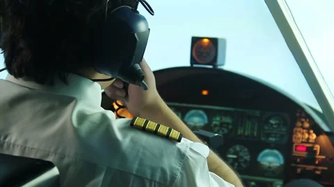 Overworked annoyed pilot operating plane and reporting situation to dispatcher Stock Footage 64598216