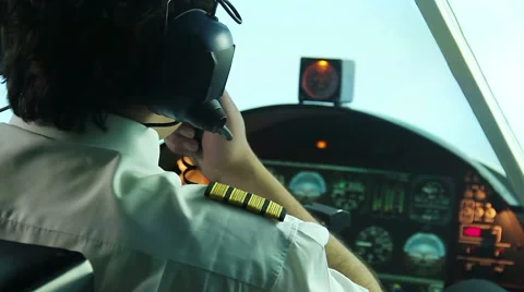 Overworked annoyed pilot operating plane and reporting situation to dispatcher Stock Footage 64601571