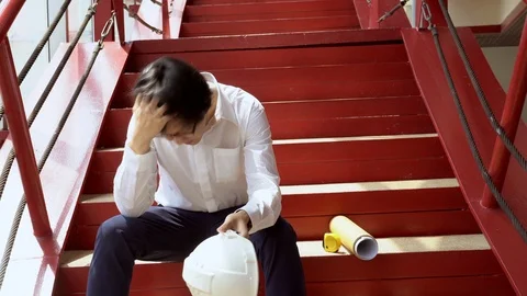 Overworked Asian engineer feeling stressed and tried at construction site Stock-Footage 90623322