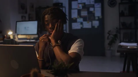Overworked Black Man Covering Face While Working Late in Office Stock Footage 338417051