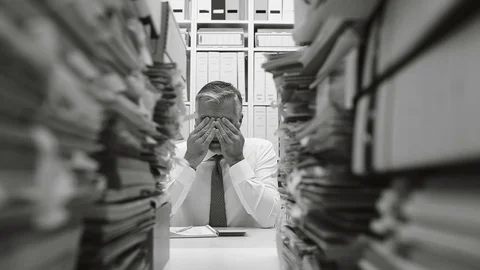 Overworked business and stacks of paperwork Stock Footage 85510786