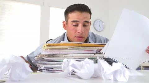 Overworked business man with large stack of papers Видео 26184331