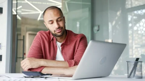 Overworked businessman is bored while sitting at desk at workplace in business  Stock Footage 311622400