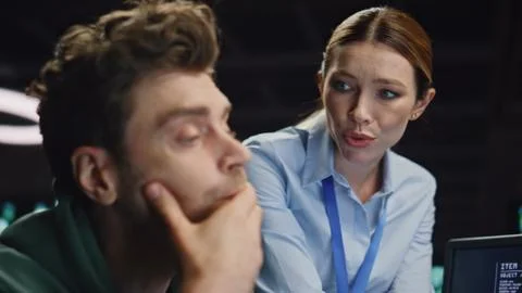 Overworked couple solving problem at office night closeup. Coworkers discussing Foto stock
