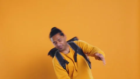 Overworked courier carrying huge stack of pizza boxes, studio background Video stock 274316279