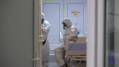 Overworked doctor in protective suit, taking a break after hard work, pandemic Vídeos de archivo 157498653