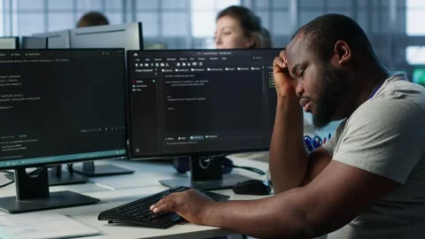 Overworked engineer falling asleep while typing on computer in server hub Stock Footage 319252041