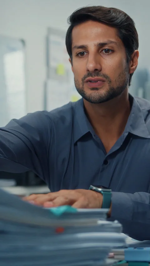 Overworked Latin businessman read document at office. Stock-Footage 344789975