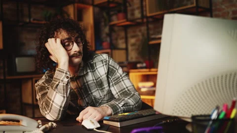 Overworked male programmer from 80s falling asleep at computer, office fatigue Stock Footage 315456553