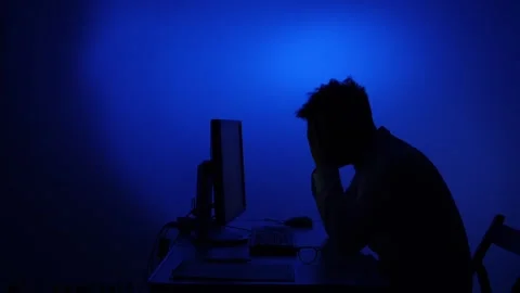 Overworked man experiencing stress and burnout working late night Stock Footage 318980807