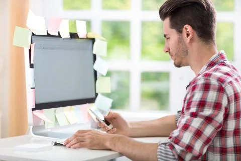 Overworked man with stickers on computer Foto stock