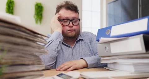Overworked office man overwhelmed by paperwork, stress and fatigue at messy desk Stock Footage 340698533