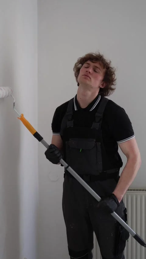 Overworked painter dozes off during apartment renovation Stock Footage 334592682