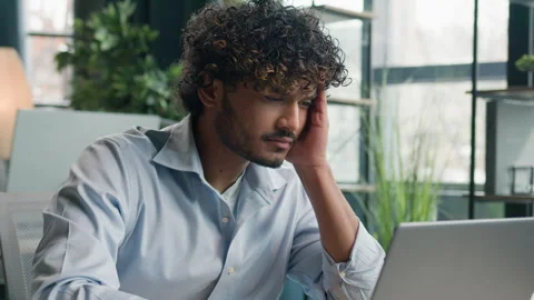 Overworked tired Arabian hispanic guy indian man sick office manager employee Stock Footage 244490321