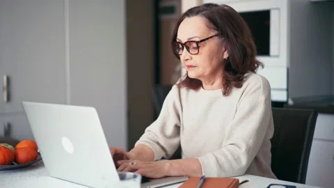 Overworked tired older lady having eyesight problem after computer work. Stock Footage 152198405