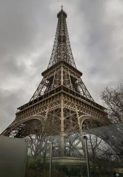 Ow angle shot of Famous Eiffel tower iron structure with dark sky background. 写真素材