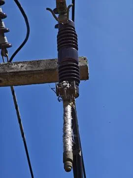 Ow angle view of high voltage electrical drop out fuse cutout device. Stock Photos