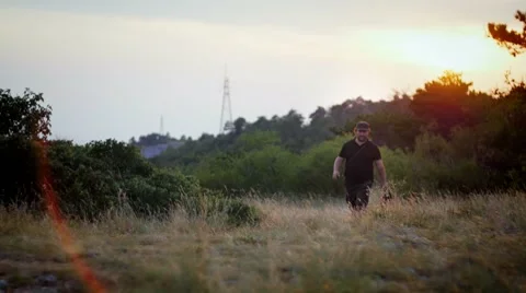 Owner and german shepherd walking in the fields on the sunset Video stock 59966211