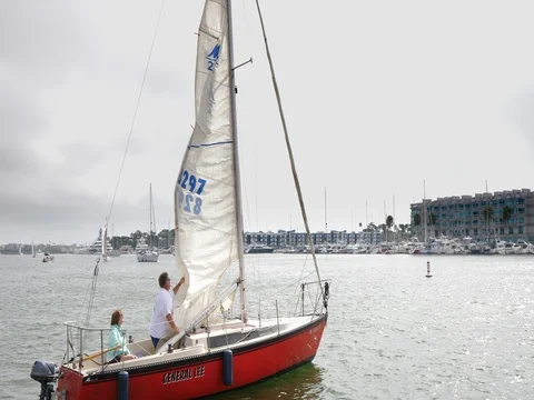 Owner of the boat taking down the sail from General Lee sailboat in Los Angeles Stock Footage 79474307