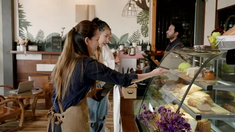 Owner cafe is standing chatting order a cake, woman is introducing differen.. Stock Footage 247045379
